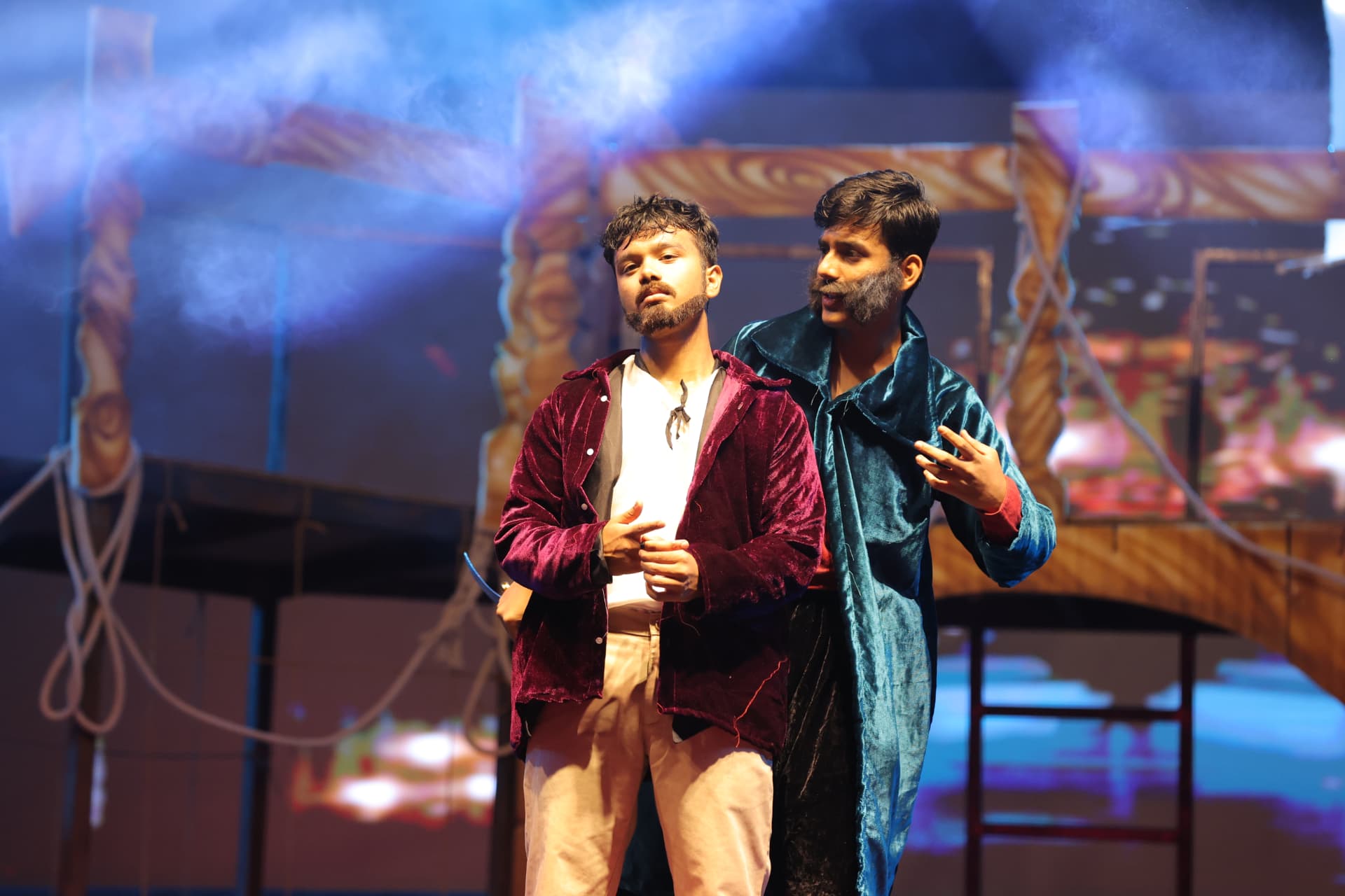 Two actors performing an intense dialogue scene on a ship deck set